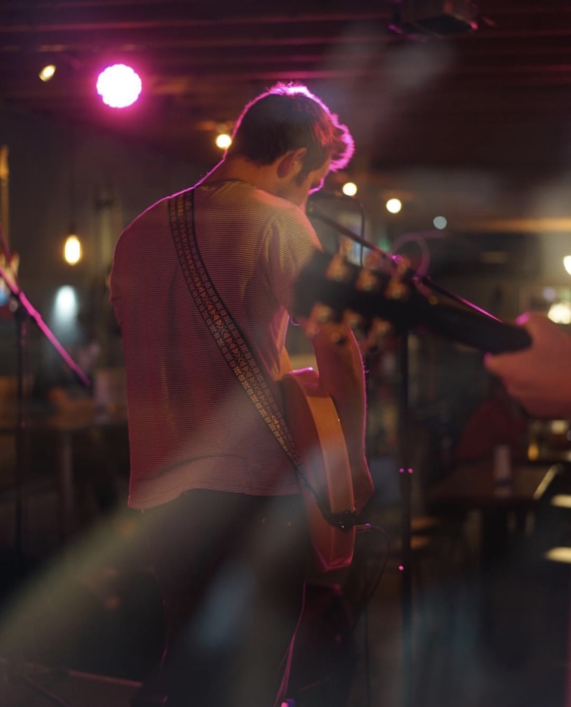 Acoustic set under pink stage light