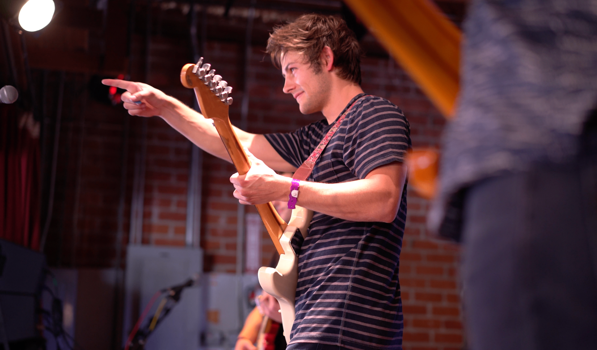 Pointing into the crowd while playing